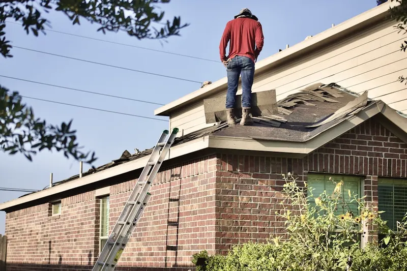Professional roofer working on a residential roof in Village of Culpeper